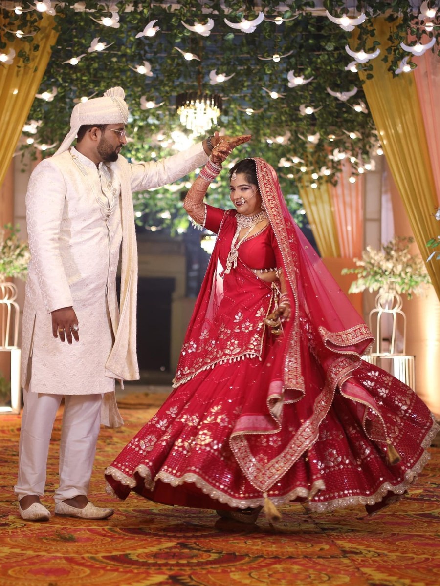 Bride and groom portrait, red bridal lehenga by Hello Beautiful Boutique
