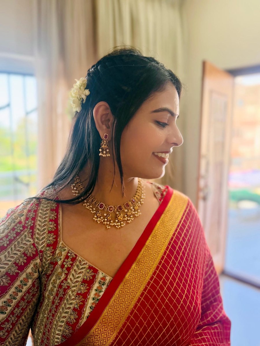 Close-up of red and gold silk saree blouse embroidery by Hello Beautiful Boutique