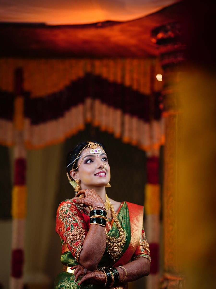 Bride in green and orange silk saree blouse at the mandap, by Hello Beautiful Boutique