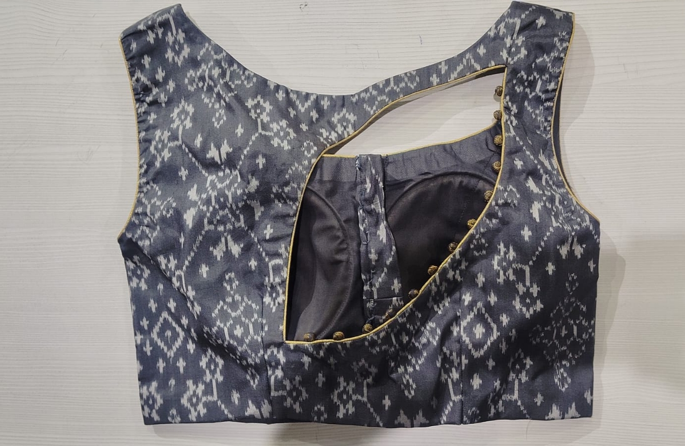 Grey ikat print blouse with cutout back and button detailing